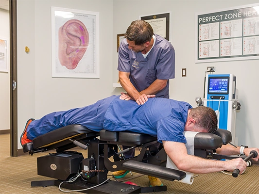 Chiropractor Centennial CO Aaron Johnson Adjusting Patient