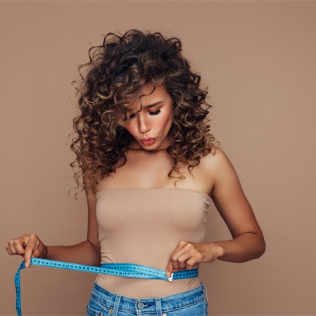 Weight Loss Centennial CO Woman Measuring Waistline